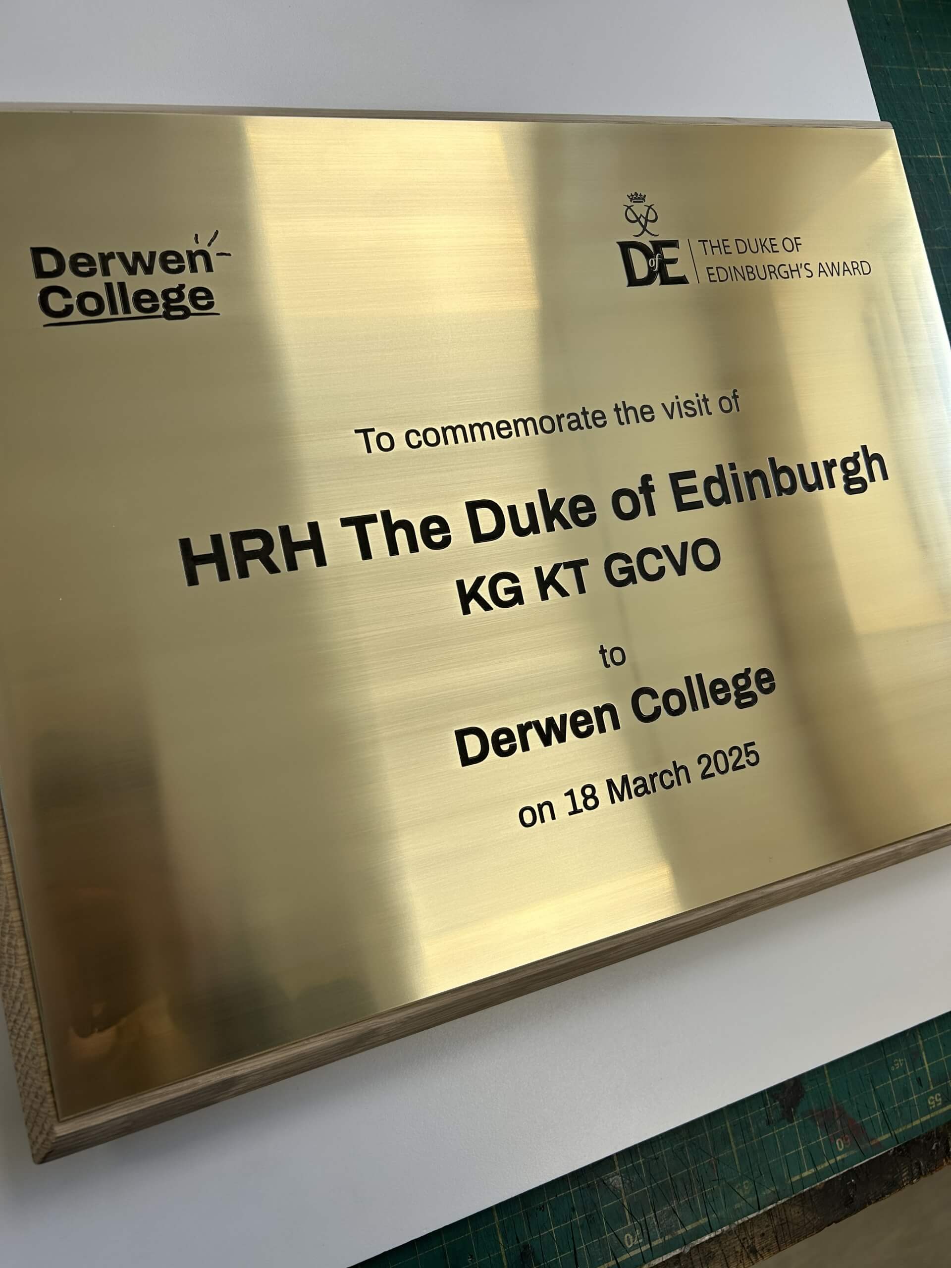 A brass plaque commemorating the Duke of Edinburgh's visit to Derwen College.