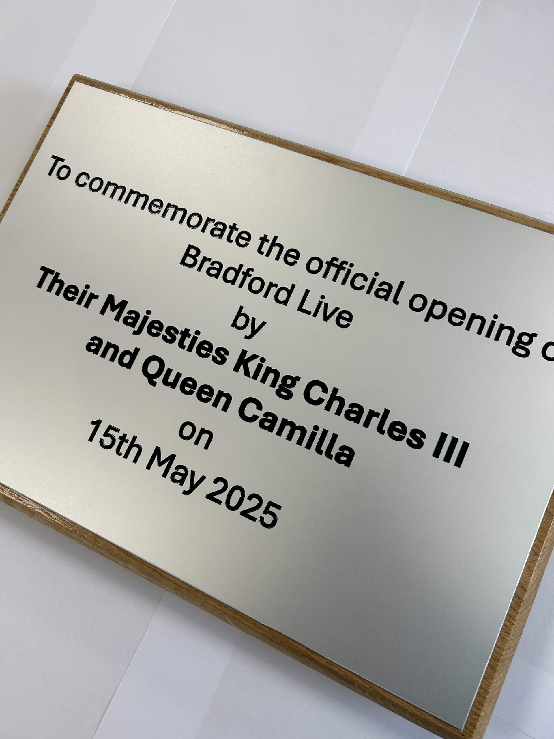 A silver plaque commemorating the opening of Bradford Live.